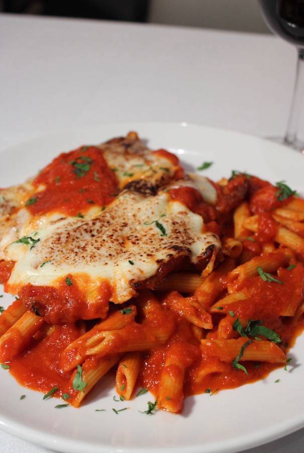 Chicken parmesan with penne in tomato sauce
